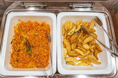two styrofoam containers of food with potatoes and carrots at Henn na Hotel Tokyo Asakusabashi in Tokyo