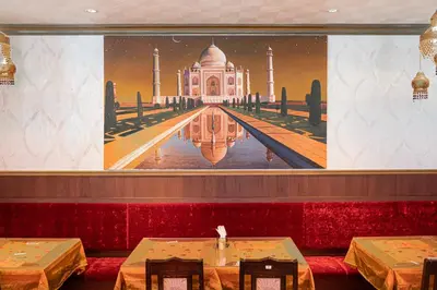 a restaurant with a large painting of the taj mahal at Henn na Hotel Tokyo Asakusabashi in Tokyo