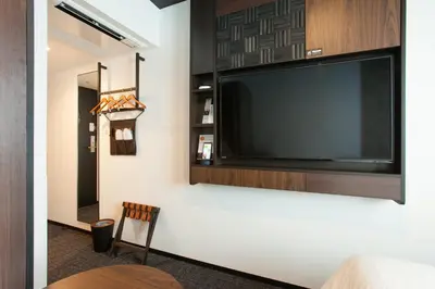 a large flat screen tv hanging on a wall at Henn na Hotel Tokyo Akasaka in Tokyo