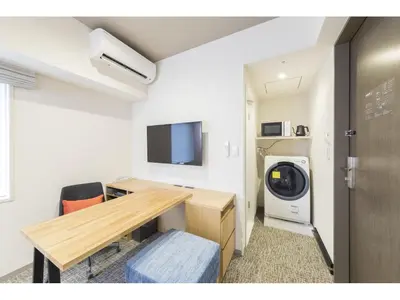 a room with a desk and a washing machine at Tokyu Stay Takanawa Shinagawa Area in Tokyo