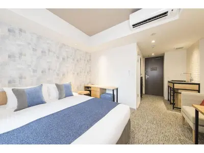 a hotel room with a bed and a desk and a kitchen at Tokyu Stay Takanawa Shinagawa Area in Tokyo