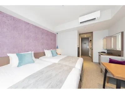 a hotel room with two beds and a table at Tokyu Stay Takanawa Shinagawa Area in Tokyo