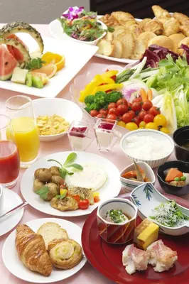 a table with many plates of food on it at Tokyo Green Palace in Tokyo