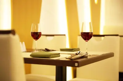 two glasses of red wine sitting on a table at Tokyo Green Palace in Tokyo