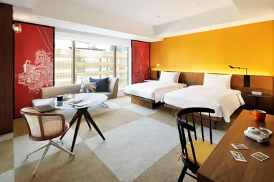 a hotel room with two beds and a table at Hyatt Centric Ginza Tokyo in Tokyo