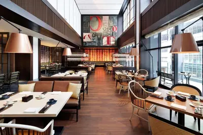 a restaurant with tables and chairs and windows at Hyatt Centric Ginza Tokyo in Tokyo