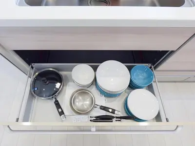 a drawer filled with bowls and utensils in a kitchen at THE HOUSE Ikebukuro Sugamo in Tokyo