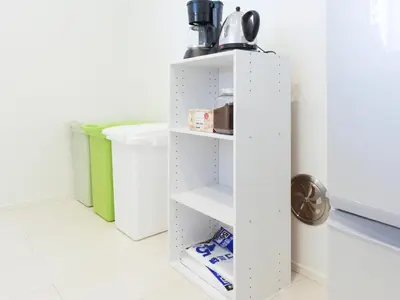 a white cupboard in a kitchen with at THE HOUSE Ikebukuro Sugamo in Tokyo