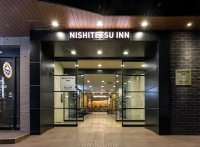 an entrance to a building with a sign on it at Nishitetsu Inn Shinjuku in Tokyo