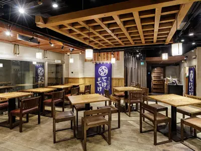 a dining room with wooden tables and chairs at Nishitetsu Inn Shinjuku in Tokyo