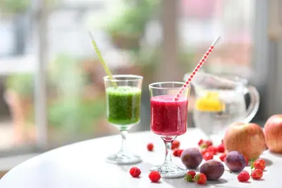 two glasses of juice and fruit on a table at Hotel Intergate Tokyo Kyobashi in Tokyo