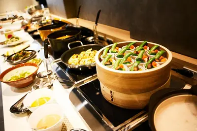 a stove top with a large pot of food on it at Hotel Intergate Tokyo Kyobashi in Tokyo