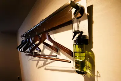 a rack of wine glasses and a bottle on a wall at Hotel Intergate Tokyo Kyobashi in Tokyo