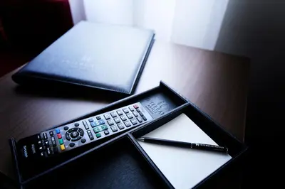 a remote control and a wallet on a table at Hotel Intergate Tokyo Kyobashi in Tokyo