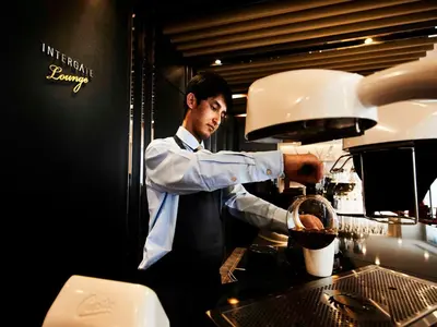 a man is preparing food in a kitchen at Hotel Intergate Tokyo Kyobashi in Tokyo