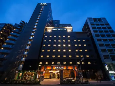 a hotel with a sign on the side of a building at APA Hotel & Resort Nishishinjuku Gochome Ekimae Tower - Formerly APA Hotel & Resort Nishishinjuku Gochome Eki Tower in Tokyo