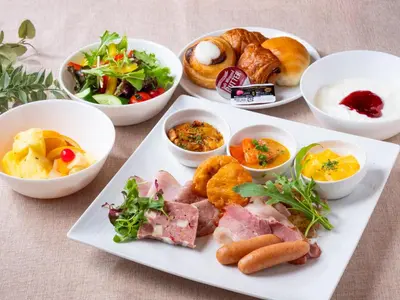a plate of food with different types of food at APA Hotel & Resort Nishishinjuku Gochome Ekimae Tower - Formerly APA Hotel & Resort Nishishinjuku Gochome Eki Tower in Tokyo