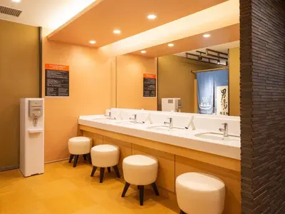 a bathroom with three sinks and a mirror at APA Hotel & Resort Nishishinjuku Gochome Ekimae Tower - Formerly APA Hotel & Resort Nishishinjuku Gochome Eki Tower in Tokyo