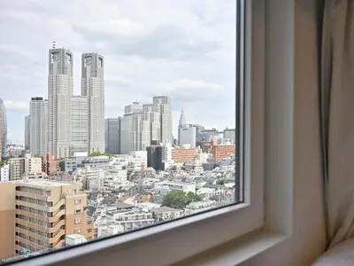 a view of a city from a window at APA Hotel & Resort Nishishinjuku Gochome Ekimae Tower - Formerly APA Hotel & Resort Nishishinjuku Gochome Eki Tower in Tokyo