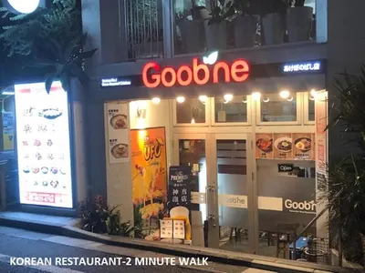 a restaurant with a neon sign in front of it at Shinjuku Central Apartment 203 in Tokyo