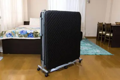 a black chair in a bedroom with a bed at Shinjuku Central Apartment 203 in Tokyo