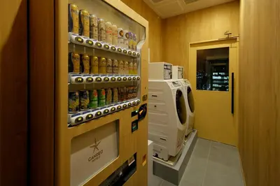 a room with a drink dispenser on the wall at Candeo Hotels Tokyo Shimbashi in Tokyo