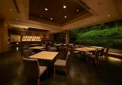 a restaurant with tables and chairs and a bar at Tokyo Prince Hotel in Tokyo