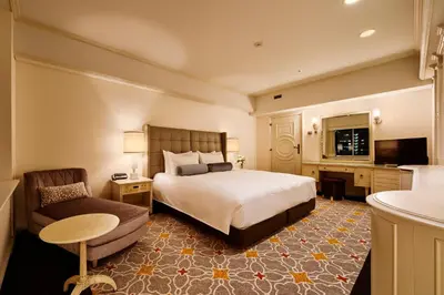 a hotel room with a bed and a couch at Tokyo Prince Hotel in Tokyo