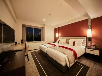 a hotel room with a large bed and a large window at Tokyo Prince Hotel in Tokyo