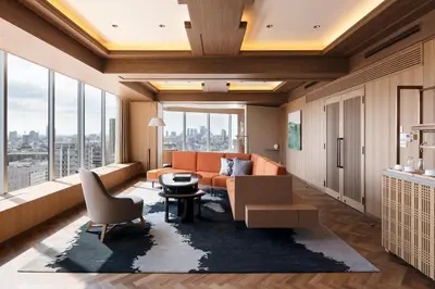 a living room with an orange couch and a large window at The Prince Park Tower Tokyo - Preferred Hotels & Resorts, LVX Collection in Tokyo