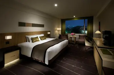 a hotel room with a large bed and a desk at The Prince Sakura Tower Tokyo, Autograph Collection in Tokyo
