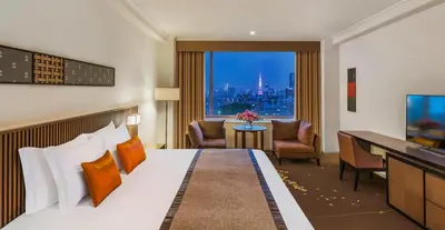 a hotel room with a bed and a view of a city at The Prince Sakura Tower Tokyo, Autograph Collection in Tokyo