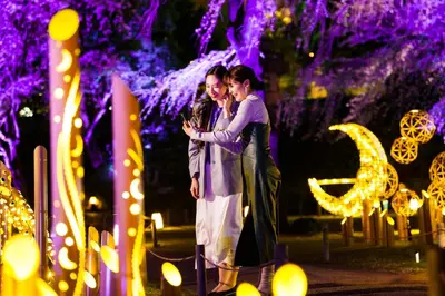 a man and woman standing in front of a display of lights at The Prince Sakura Tower Tokyo, Autograph Collection in Tokyo