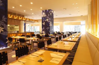 a dining room with wooden tables and chairs at Grand Prince Hotel Takanawa in Tokyo