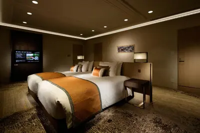 a hotel room with two beds and a television at Grand Prince Hotel Takanawa in Tokyo