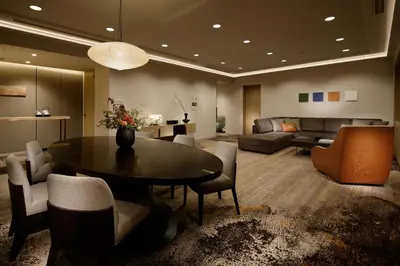 a living room with a table and chairs and a couch at Grand Prince Hotel Takanawa in Tokyo