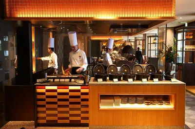a group of chefs preparing food in a kitchen at Grand Prince Hotel Shin Takanawa in Tokyo