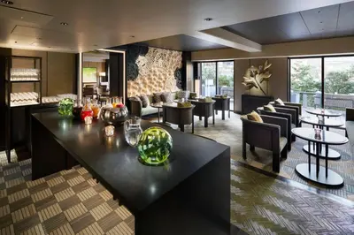 a lobby with a bar and tables and chairs at Grand Prince Hotel Shin Takanawa in Tokyo