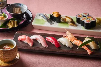 a plate of sushi and other food on a table at Shinagawa Prince Hotel in Tokyo