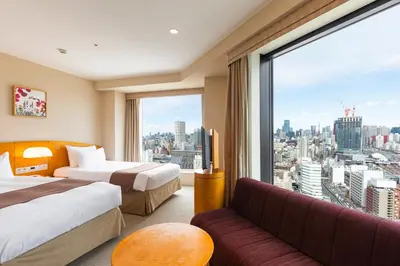 a hotel room with two beds and a large window at Shinagawa Prince Hotel in Tokyo