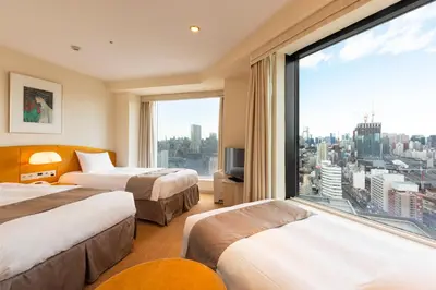 a hotel room with two beds and a large window at Shinagawa Prince Hotel in Tokyo