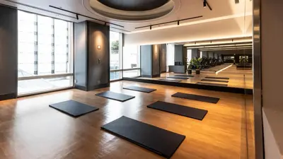 a yoga room with black mats on the floor at Shinagawa Prince Hotel in Tokyo