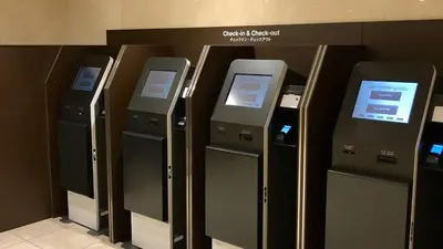 a row of atm machines lined up against a wall at Shinagawa Prince Hotel in Tokyo