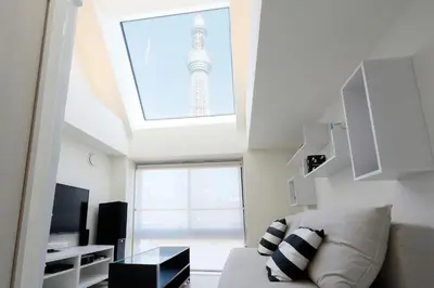 a living room with a view of the eiffel tower at La Krasse Sumida in Tokyo
