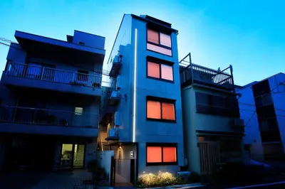 a building with red and orange lights on it at La Krasse Sumida in Tokyo