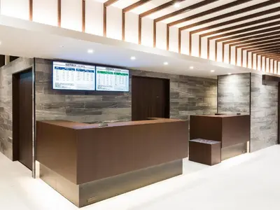 an office lobby with a desk and a monitor on the wall at Sunshine City Prince Hotel Ikebukuro Tokyo in Tokyo