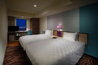 a hotel room with two beds and a television at Sunshine City Prince Hotel Ikebukuro Tokyo in Tokyo