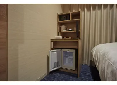 a tv in a corner of a room with a bed at Sunshine City Prince Hotel Ikebukuro Tokyo in Tokyo