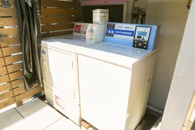 a washing machine with a box on top of it at Hostel Chapter Two Tokyo in Tokyo