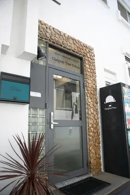 an entrance to a building with a glass door at Hostel Chapter Two Tokyo in Tokyo